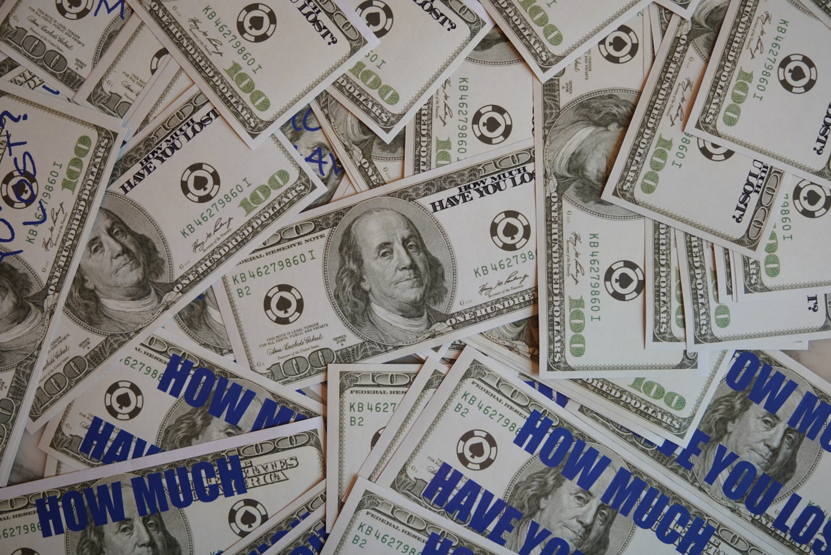 Stack of printed anti-gambling $100 bill stickers